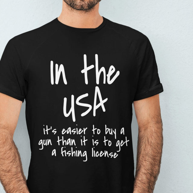 in-the-usa-its-easier-to-buy-a-gun-than-it-is-to-get-a-fishing-license-usa-tee-government-t-shirt-buy-tee-t-shirt-tee#color_black