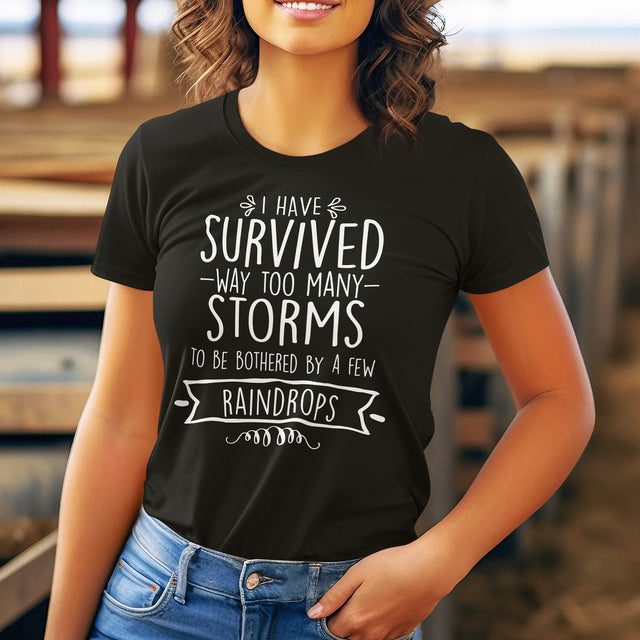 i-have-survived-way-too-many-storms-to-be-bothered-by-a-few-raindrops-life-tee-survived-t-shirt-resilience-tee-storms-t-shirt-life-tee#color_black