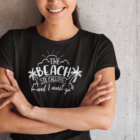 the-beach-is-calling-and-i-must-go-beach-tee-ocean-t-shirt-surfing-tee-outdoors-t-shirt-travel-tee#color_black