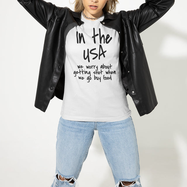 in-the-usa-we-think-about-getting-shot-when-we-go-buy-food-usa-tee-government-t-shirt-shot-tee-t-shirt-tee#color_white